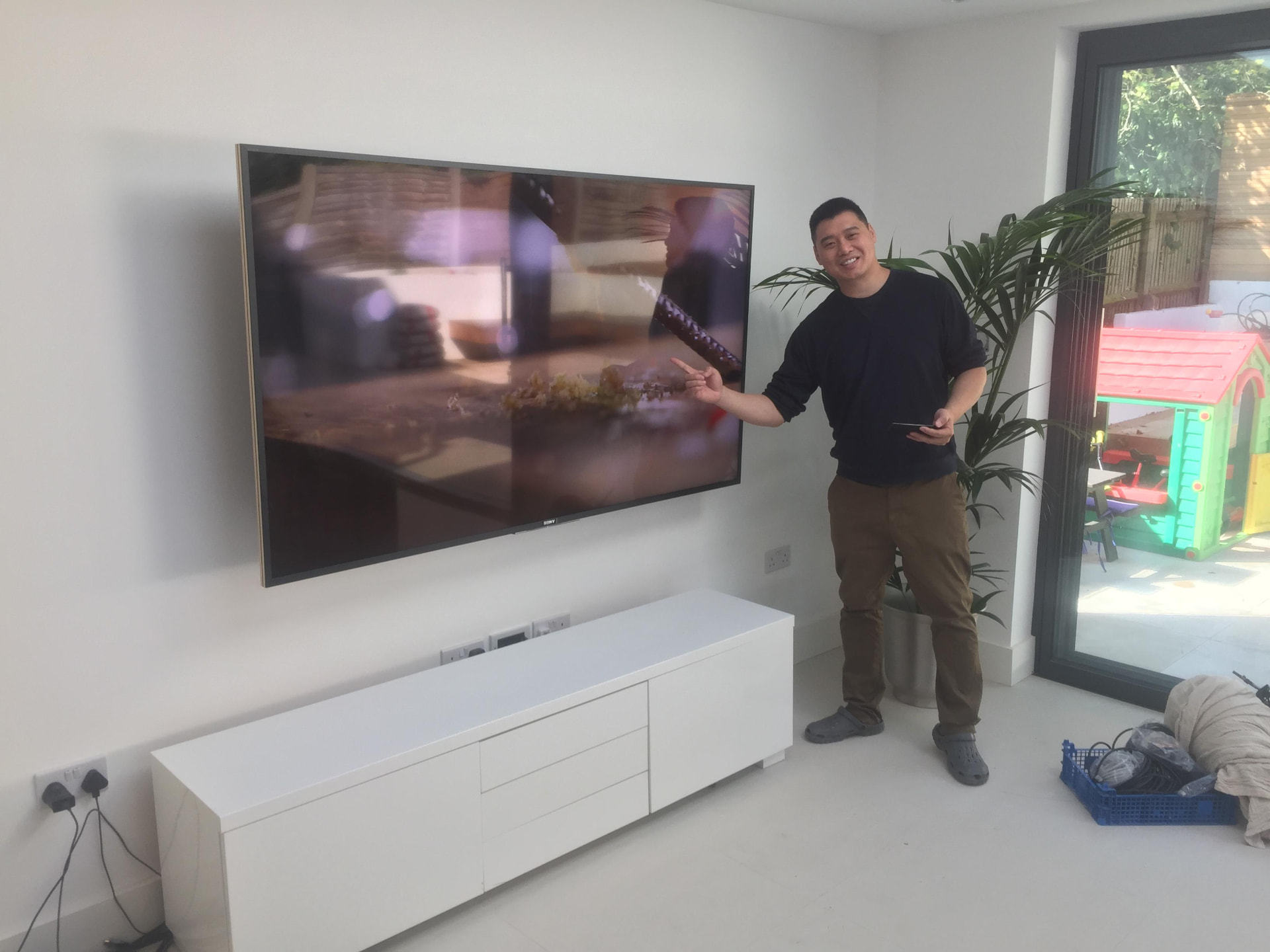 Large flat-screen TV professionally wall mounted with hidden cables